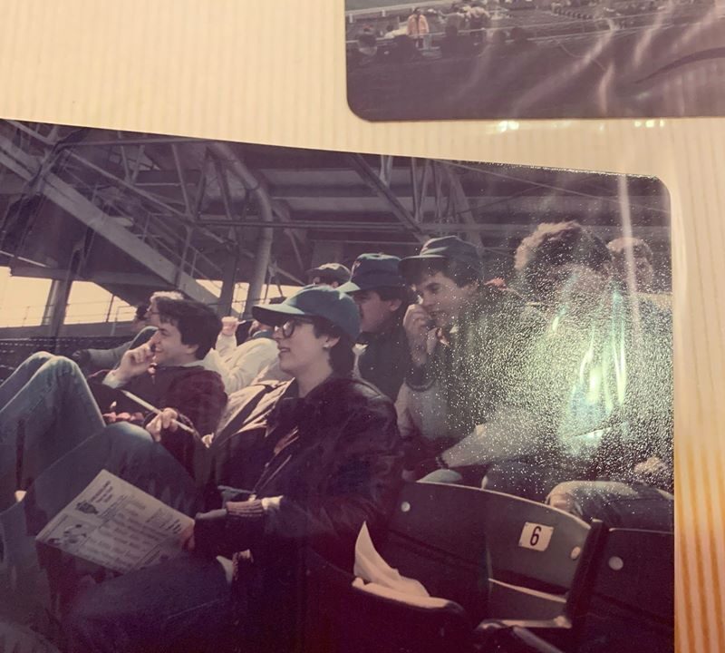 Group of Class of 1985 students sitting in bleacher seats